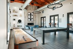 San Antonio apartment for rent - A pool table is in the middle of a room with a couch and a chair.