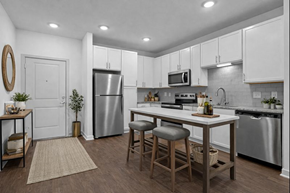 Bloomingdale apartment for rent - A kitchen with white cabinets and a wooden island.