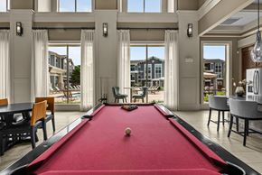 College Station apartment for rent - A pool table in a room with a view of the outside.
