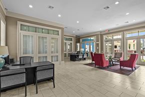 College Station apartment for rent - A spacious office with a desk, chairs, and a large window.