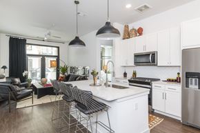 Savannah apartment for rent - A modern kitchen with a white island and stainless steel appliances.