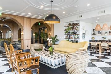 Savannah apartment for rent - A living room with a yellow sofa and a black and white checkered floor.