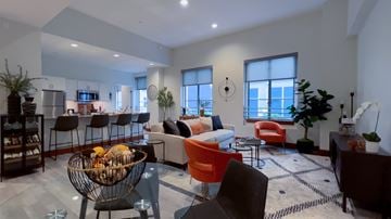 Long Beach apartment for rent - A modern living room with a glass table and a variety of seating options.