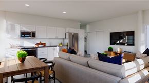 Long Beach apartment for rent - A modern kitchen with a dining table and a grey couch.