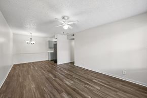 Stephenville apartment for rent - A room with a ceiling fan and wooden flooring.