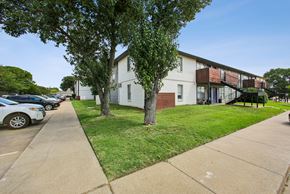 Stephenville apartment for rent - A white building with a tree in front of it.