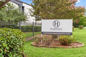 Dallas apartment for rent - A sign for Harwell Apartments is displayed in front of a building.