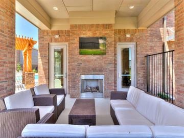 Oklahoma City apartment for rent - the outdoor living room has a brick fireplace and couches