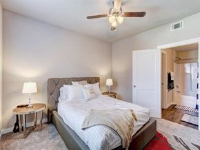 Oklahoma City apartment for rent - a bedroom with a bed and a ceiling fan