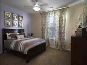 Oklahoma City apartment for rent - a bedroom with a bed and a ceiling fan