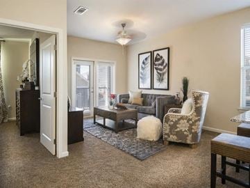 Oklahoma City apartment for rent - a living room with furniture and a door to a balcony