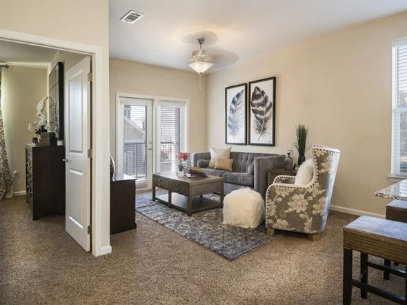 Oklahoma City apartment for rent - a living room with furniture and a door to a balcony