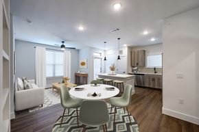 Katy apartment for rent - A modern dining room with a white table and chairs.