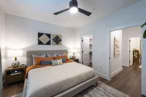 Katy apartment for rent - A bedroom with a large bed and a ceiling fan.