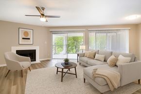 Fort Worth apartment for rent - A living room with a fireplace, a chair, a couch, and a coffee table.