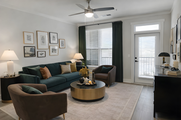 Panama City Beach apartment for rent - A living room with a green couch, a brown armchair, and a coffee table.