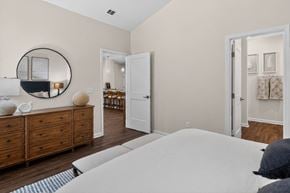 Pooler apartment for rent - A bedroom with a large bed, a dresser, and a mirror.
