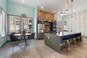 Pflugerville apartment for rent - A kitchen with a dining table and chairs.