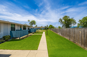 Panama City apartment for rent - the yard of a home with green grass and a sidewalk