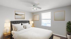 Panama City apartment for rent - a bedroom with a large bed and a ceiling fan