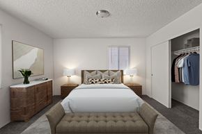 Yuma apartment for rent - A bedroom with a large bed and a wooden dresser.