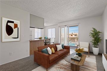 Yuma apartment for rent - A living room with a brown couch and a painting on the wall.