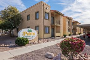 Yuma apartment for rent - A building with a sign that says Palms Apartments.