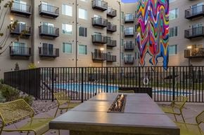 Aurora apartment for rent - A colorful mural on a building behind a pool.