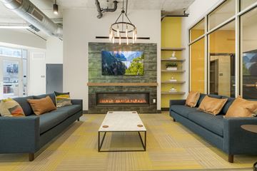 Aurora apartment for rent - A modern living room with a fireplace and a television mounted above it.
