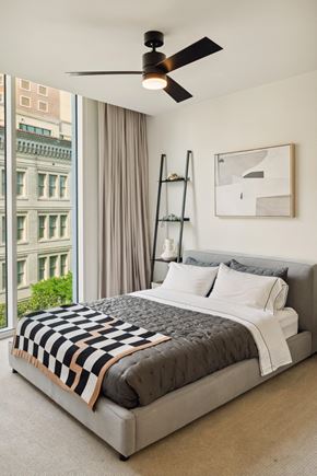 San Antonio apartment for rent - A bedroom with a large bed and a ceiling fan.