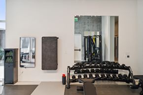 San Antonio apartment for rent - A gym with a row of dumbbells and a bench.