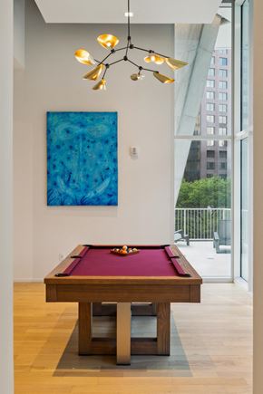 San Antonio apartment for rent - A pool table with a red cloth and a pool cue on it.