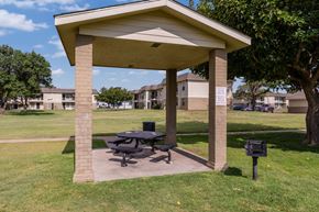 Amarillo apartment for rent - A picnic table is under a pavilion in a grassy area.