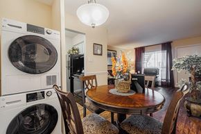 Houston apartment for rent - a dining room with a table and chairs and a washer and dryer