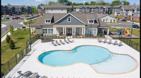 Columbia apartment for rent - an aerial view of a swimming pool with chairs in front of a house