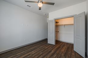 Katy apartment for rent - a bedroom with hardwood floors and a ceiling fan