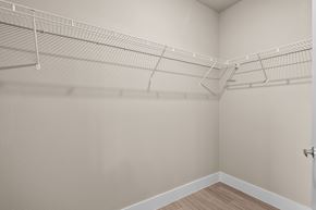 College Station apartment for rent - our spacious closets in the living room of a home with white walls and shelves