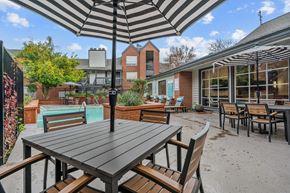 Austin apartment for rent - an outdoor patio with tables and chairs and a pool