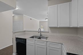 Killeen apartment for rent - a kitchen with white cabinets and a sink
