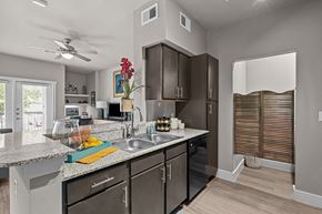 College Station apartment for rent - an open kitchen with stainless steel appliances and granite counter tops