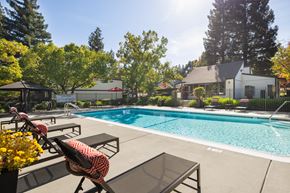 Auburn apartment for rent - A pool with a table and chairs in front of it.