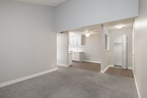 Auburn apartment for rent - A spacious, empty room with a carpeted floor and white walls.