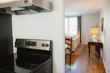 Nashville apartment for rent - A black stove top oven in a kitchen with a wooden floor.