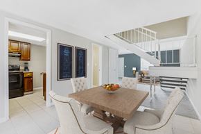 Forest Park apartment for rent - a dining area with a wooden table and chairs and a kitchen with a staircase