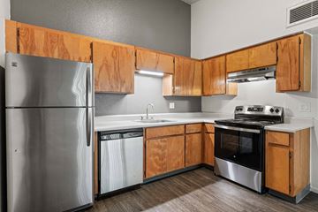Yuma apartment for rent - A kitchen with wooden cabinets and stainless steel appliances.