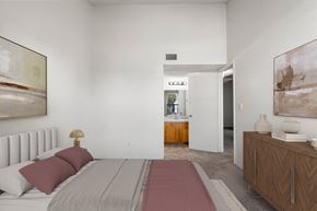 Yuma apartment for rent - A bedroom with a large bed and a painting on the wall.