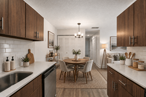 Brandon apartment for rent - A modern kitchen with wooden cabinets and a dining table.