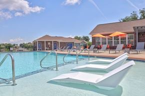 Antioch apartment for rent - A pool with a white sun lounger in the foreground.