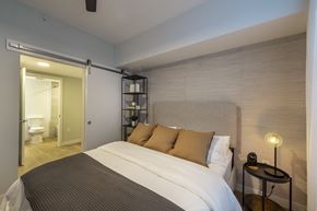 Houston apartment for rent - a bedroom with a bed and a bathroom with a toilet