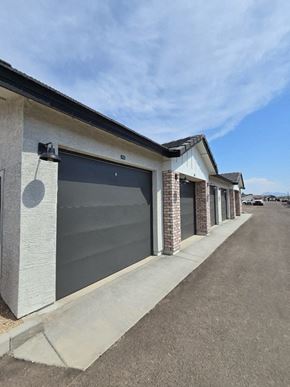 Surprise apartment for rent - A row of houses with grey roofs and dark grey garage doors.